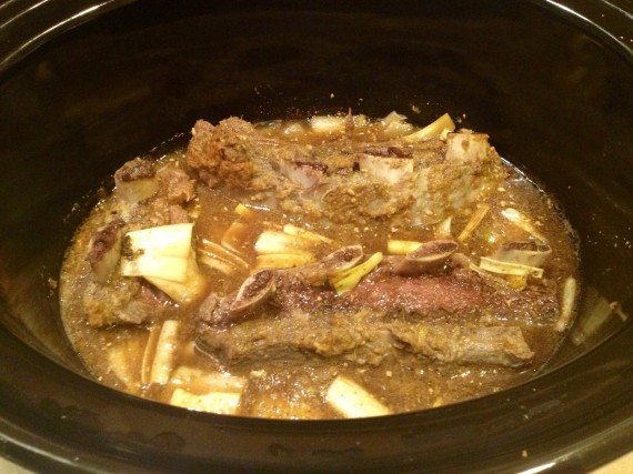 Mid-cooking, moving short ribs around.