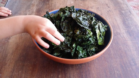 Roasted Kale with Ghee and a little kiddo's hand grabbing for some.