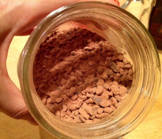 Raw cacao nibs mixed in a jar with raw cacao "chocolate" powder