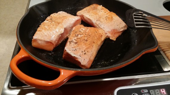 Wild Caught Salmon getting sear on skin side. Meat side already done.