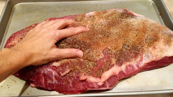 Rubbing the rub onto both sides of the brisket. OMG my arms are hairy. #Italian. 