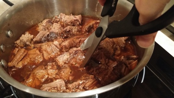Cutting up brisket with kitchen shears for easier consumption. I don't mess around.