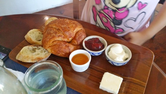 Croissant, bread, and spreads.
