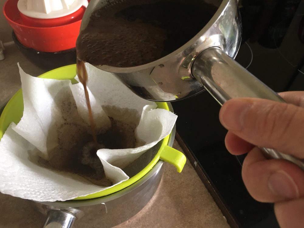 Straining coffee grounds out
